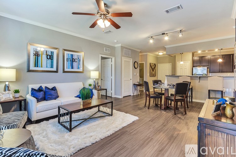 A living room with a white couch and a zebra print rug.