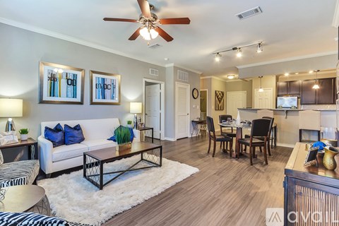 A living room with a white couch and a zebra print rug.