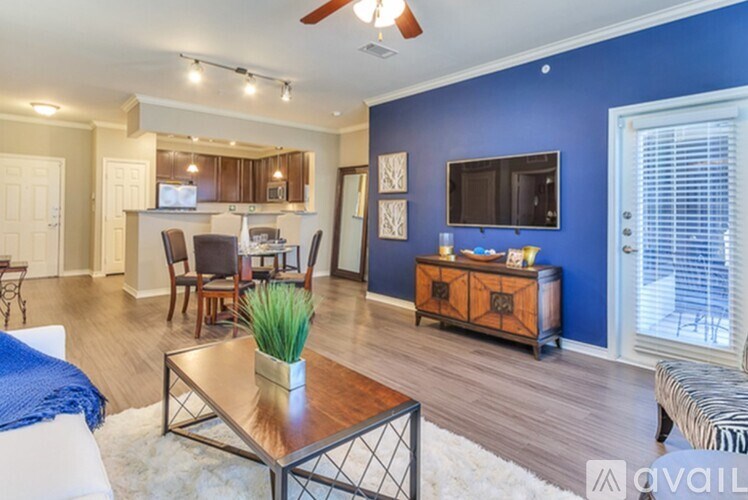 A living room with a blue wall and a television.