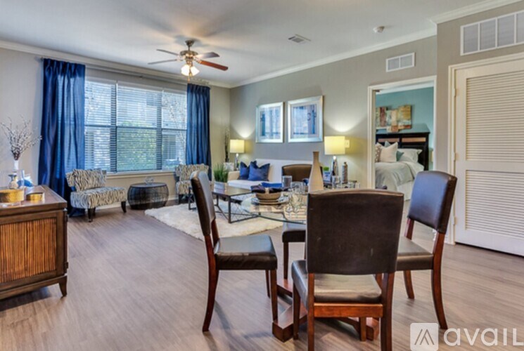 A living room with a dining table and chairs.