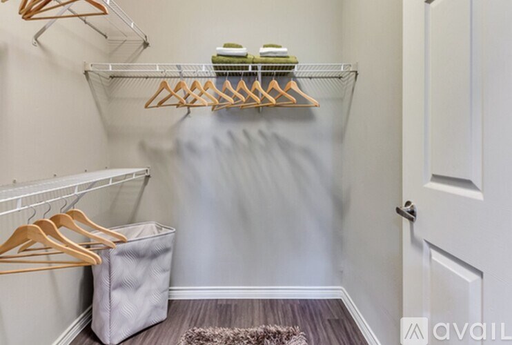 A hallway with a white door and a grey bag on the floor.