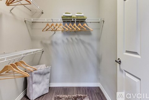 A hallway with a white door and a grey bag on the floor.