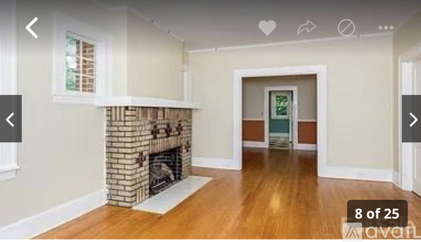 A room with a fireplace and a window.