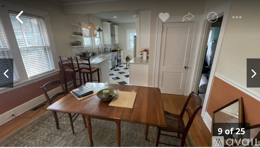 A kitchen with a table and chairs in the foreground.