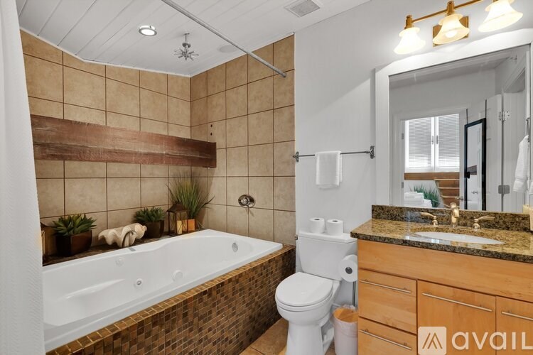 A bathroom with a tub, toilet, and sink.