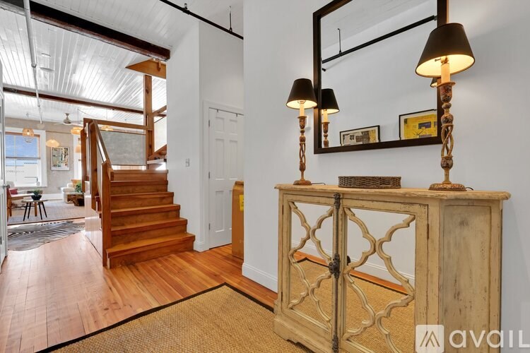 A wooden staircase leads to the upper floor of a house.