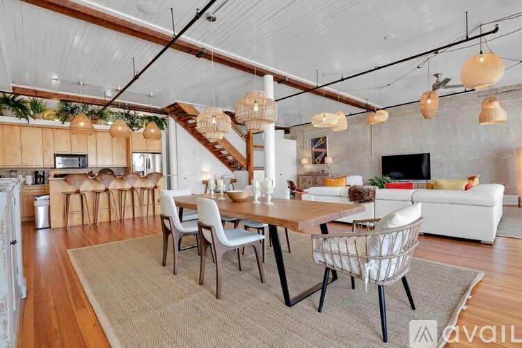 A modern dining room with a wooden table and chairs.