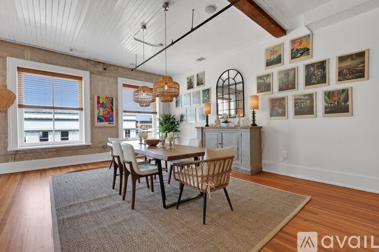 A dining room with a wooden table and chairs.