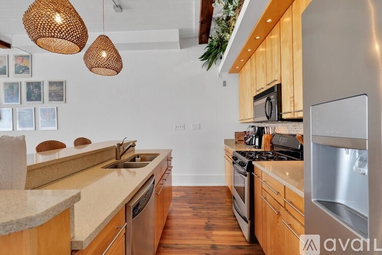 A kitchen with wooden cabinets and a stainless steel refrigerator.