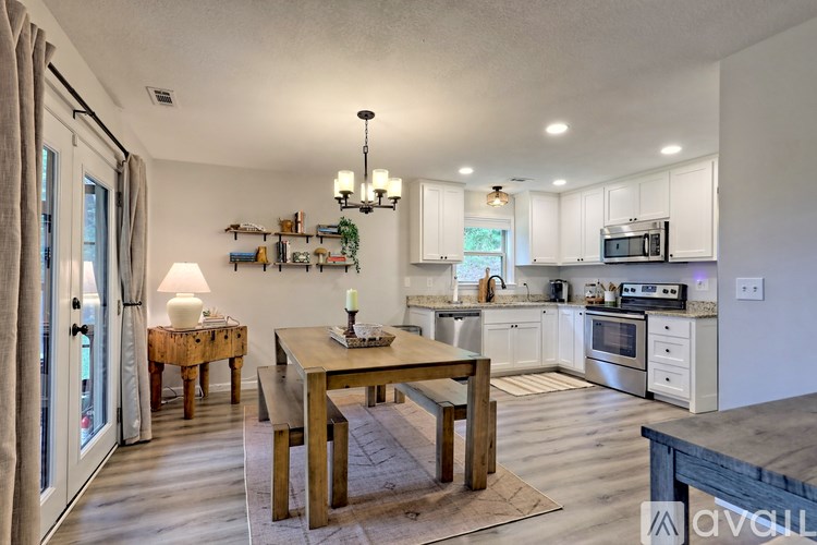 A modern kitchen with a dining table and chairs.