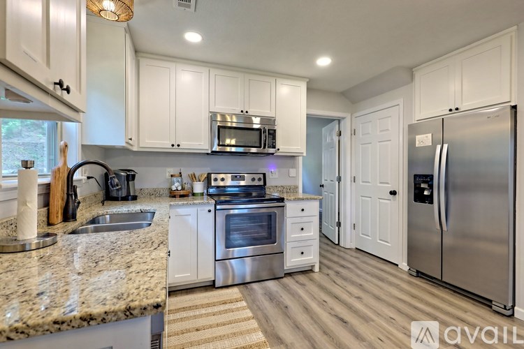 A kitchen with granite countertops and stainless steel appliances.
