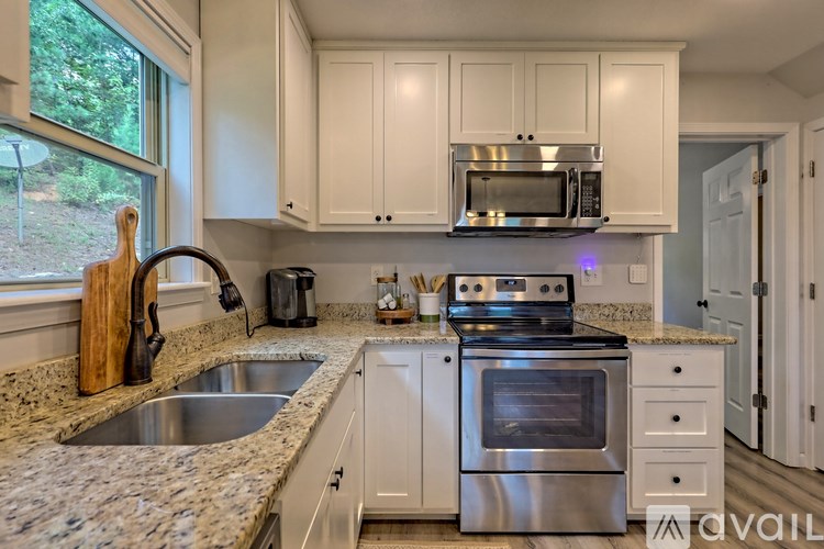 A kitchen with a stove, oven, and cabinets.