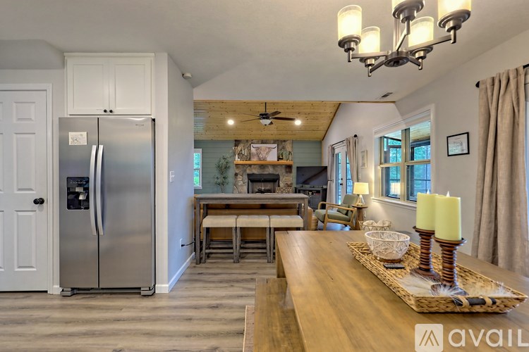A kitchen with a wooden table and a fridge.