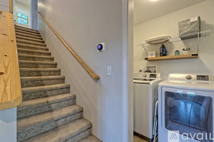 A kitchen with a washing machine and a stove.
