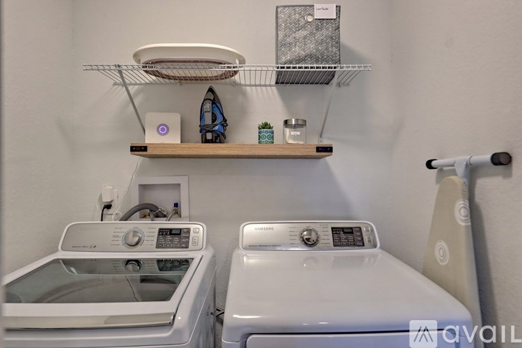 A small laundry room with a washer and dryer.