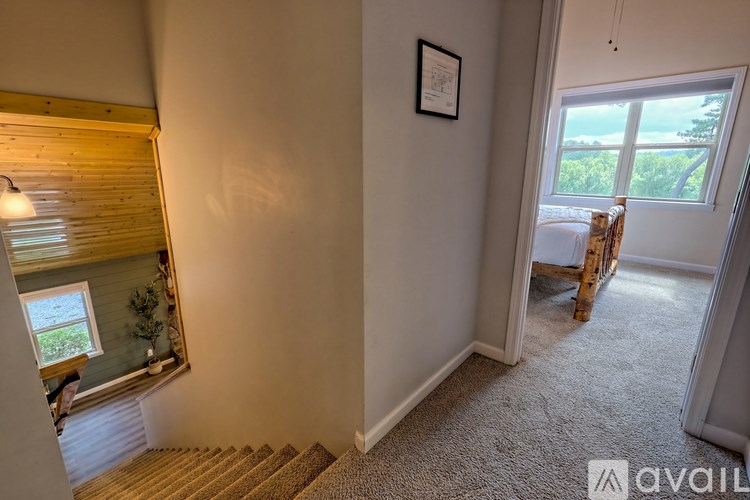 A room with a carpeted floor and a window with blinds.