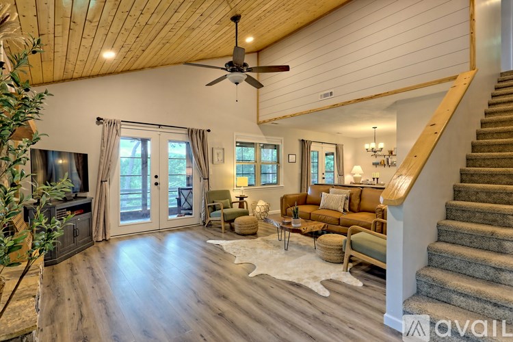A spacious living room with a staircase leading to the upper floor.