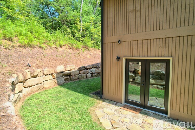 A house with a brown siding and a glass door is shown.