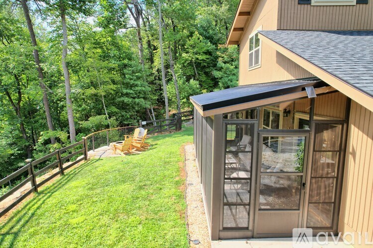 A backyard with a deck and a patio.