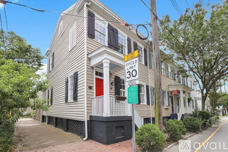 A house with a speed limit sign of 30 in front of it.