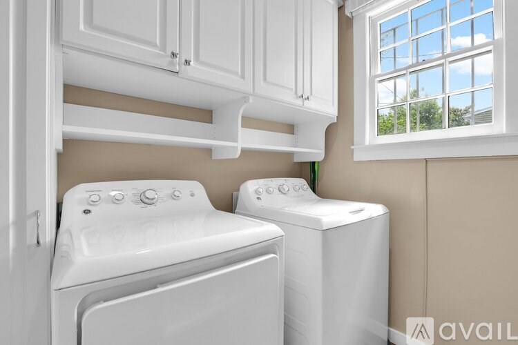A white washing machine and dryer in a laundry room.