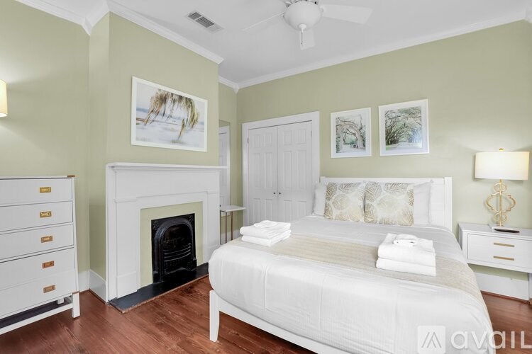 A bedroom with a fireplace and a bed.