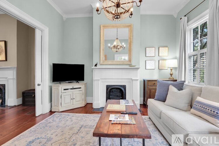 A living room with a fireplace, a couch, and a coffee table.