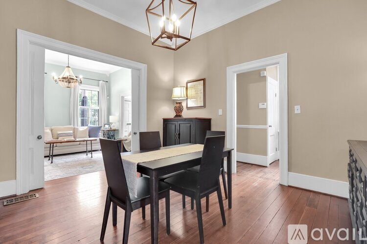 A dining room with a table and chairs.