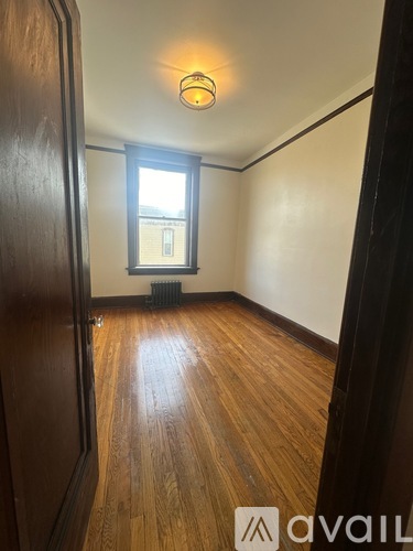 A room with wooden floors and a window.