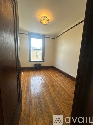 A room with wooden floors and a window.
