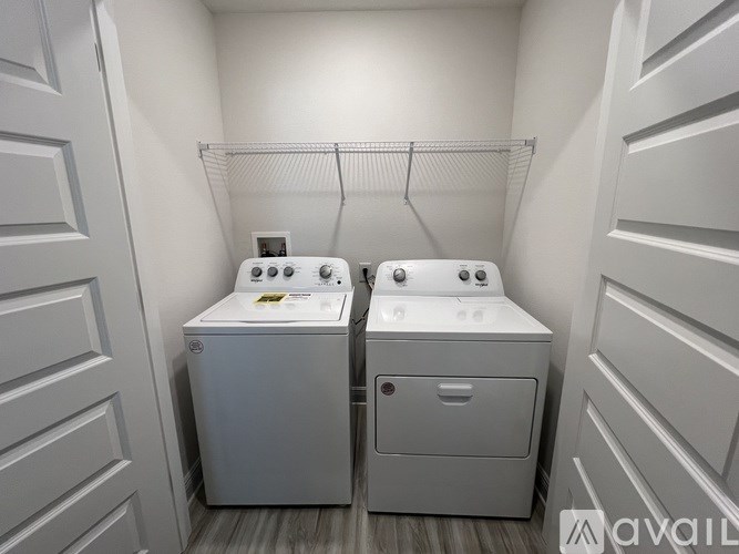 A small laundry room with a washer and dryer.