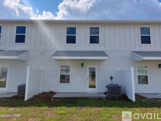 A white house with a sunroof and a garage door.