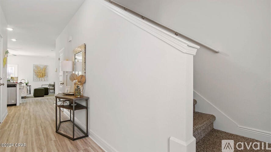 A room with a table and a mirror on the wall.