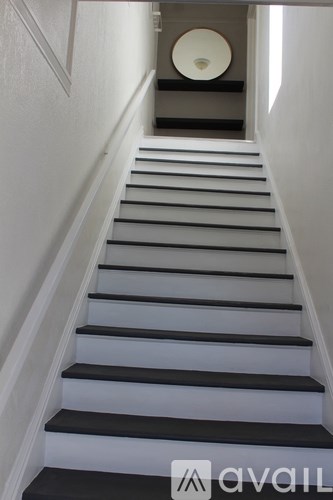 A staircase with black and white steps.