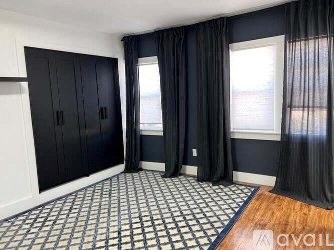 A room with black curtains and a checkered floor.