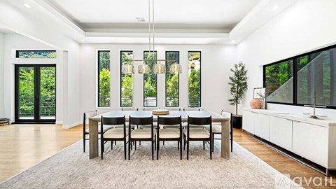 A dining room with a table set for four.