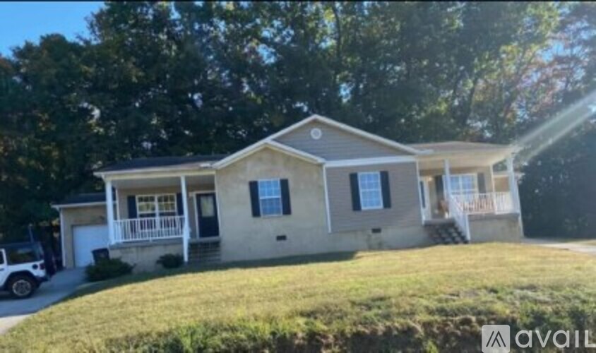 A house with a car parked in front of it.