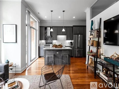 A modern kitchen with a dining area and a living room.