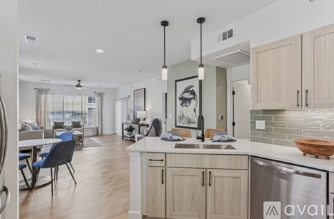 A modern kitchen with wooden cabinets and a large island.