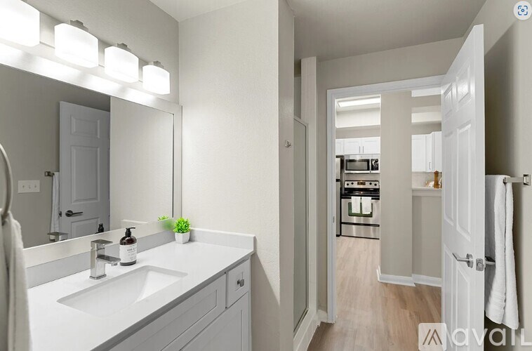 A bathroom with a white sink and a mirror above it.