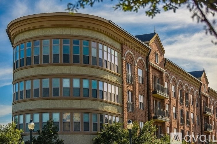 A large, curved building with many windows and balconies.