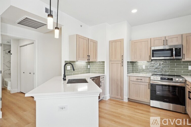 A kitchen with a white island and wooden cabinets.