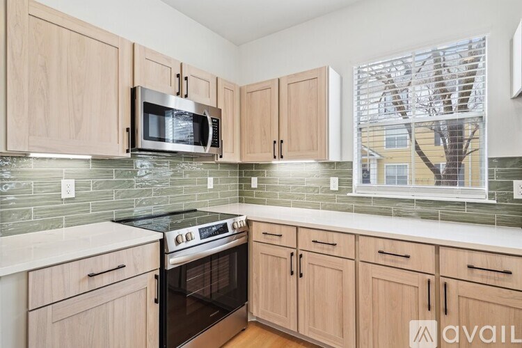 A kitchen with wooden cabinets and a black stove top oven.