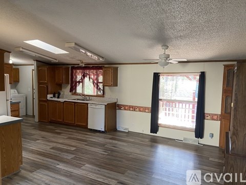 A kitchen with wooden cabinets and a white dishwasher.