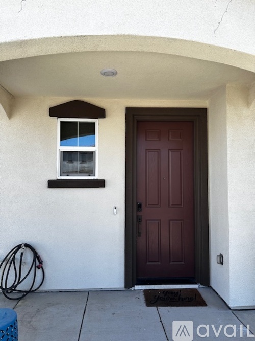 A brown door is on the right and a window is on the left.