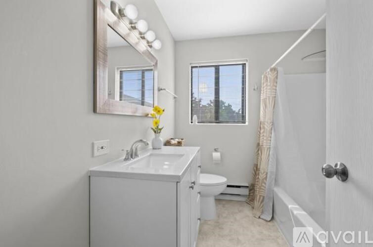 A bathroom with a white sink, toilet, and bathtub.