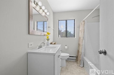 A bathroom with a white sink, toilet, and bathtub.