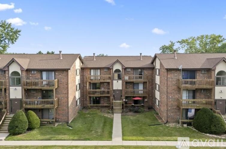 Apartment complex with a green lawn in front.