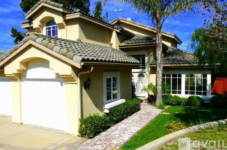 A house with a white garage door and a red awning.