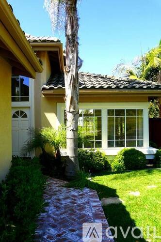 A house with a yellow wall and a white door.